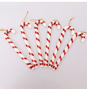Set of six red and white striped Christmas candy cane ornaments with golden hanging strings