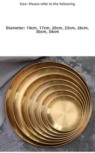 Macro view of nesting gold round metal trays showing various sizes from 14cm to 34cm