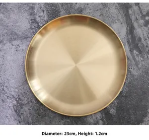 Detailed top view of 23cm gold metal storage tray with brushed texture on stone surface