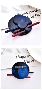 Detailed view of geometric acrylic brooch with marble texture and metal pin fastener