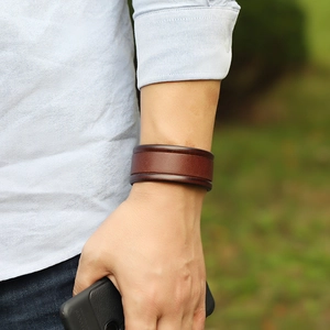 Minimalist vintage brown leather cuff bracelet for women shown on model's wrist