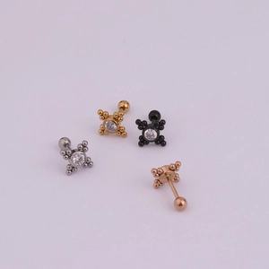 Detail of four lightning-style stainless steel cartilage studs in multi-color finishes