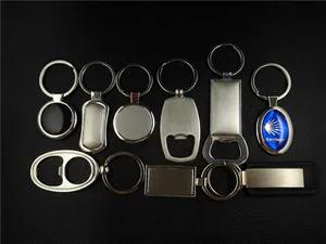 Flat lay of multiple custom beech wood and metal keychains on a textured black surface