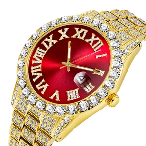 Detail of luxury gold iced-out watch with red dial, Roman numerals and calendar window