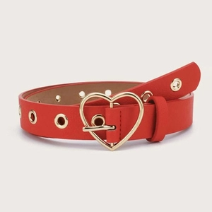 Detail of red synthetic leather belt with gold heart buckle and metal eyelets
