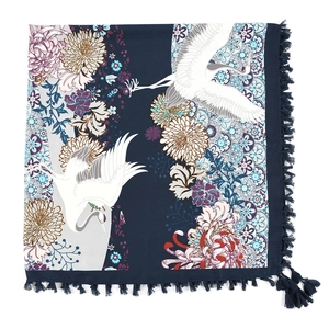 Close-up of bohemian navy blue square scarf featuring crane patterns and fringe details