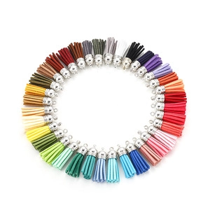 Vibrant multi-color tassel pendants with silver metal caps arranged in a creative circle