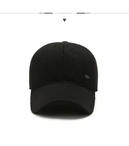 Detail of black wool baseball cap featuring premium texture and side metal emblem