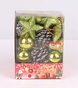 Christmas box with green stars, gold bells, pine cones and ornaments in festive packaging
