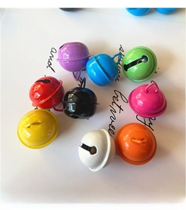 Close-up of colorful 22mm painted metal craft bells in assorted vibrant candy colors