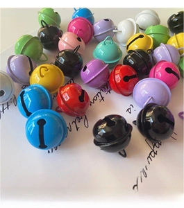 Close-up of colorful 22mm painted metal mini bells in various candy colors for DIY crafts