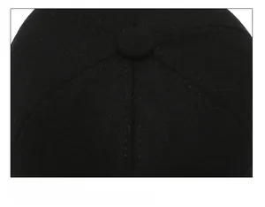 Close-up of six-panel stitched crown and top button on men's winter baseball cap