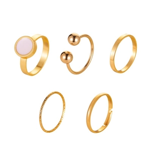 Five-piece set of gold-colored moon and star rings with a pink stone and open designs