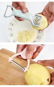 Close-up of 2-in-1 kitchen peeler and grater shredding potatoes in blue and pink colors