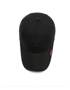 Detail of a black cotton baseball cap showing A-KURTZ embroidery and a red side label