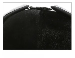 Detailed close-up of thick faux fur material and buckle clasp on the winter cap top