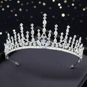 Detail of silver bridal crown featuring sparkling rhinestones and elegant pointed tiara peaks