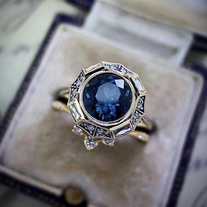 Vintage style gold-plated ring set with large blue sapphire and small white diamonds