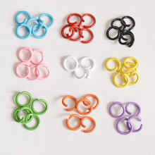 Macro detail of colorful heart-shaped alloy keychains in various painted finishes