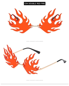 Macro detail of fire-shaped sunglasses featuring orange resin lenses and gold metal frames