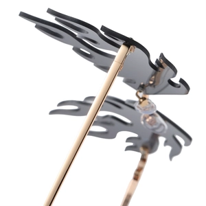 Frameless flame shaped sunglasses with grey lenses and slim gold metal temples