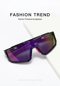 Detail of polarized oversized cycling sunglasses with blue ink splatter frame and pink nose pads