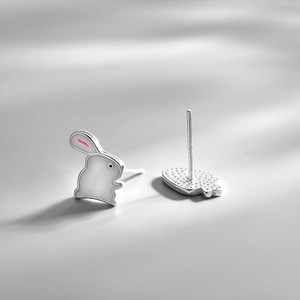 Cute S925 sterling silver rabbit earrings with pink enamel details on a minimalist background