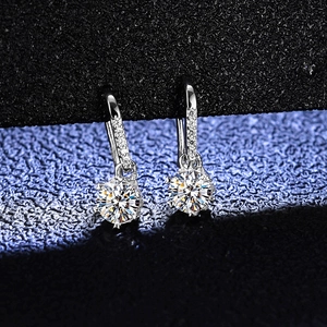 Macro detail of snowflake moissanite earrings in S925 sterling silver with round cut stones