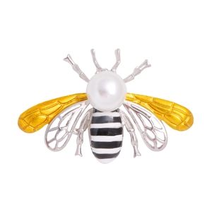 Bee brooch with yellow enamel wings and white pearl accent on a minimalist white background