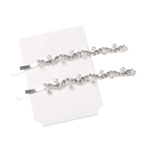 Sparkling wave-shaped hair clip set with white pearls and rhinestones on silver metal