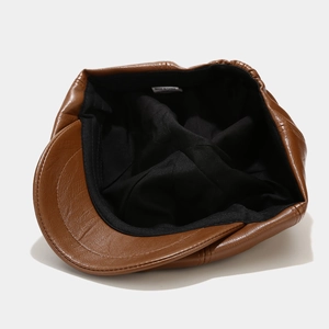Classic brown leather octagonal newsboy hat with soft black lining and fine stitching