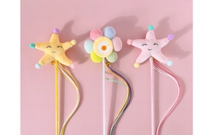 Detail of plush star and flower cat wands with colorful ribbons and small bells