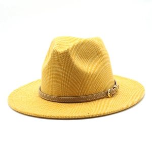 Close-up of mustard yellow fedora hat showing checkered texture and brown leather strap