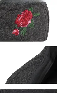 Détail de broderie rose rouge 3D et texture en feutre de laine anthracite sur casquette