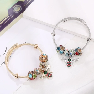 Chic bee charm beaded cuff bracelet with colorful rhinestones on stylish white marble background