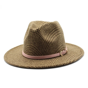 Detailed texture of brown plaid fedora hat with pink leather band and gold buckle