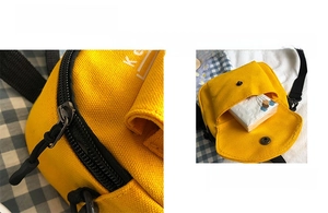 Close-up of yellow canvas crossbody bag featuring durable zippers and front flap pocket