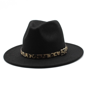 Close-up of black wool fedora featuring leopard print band and gold buckle detail