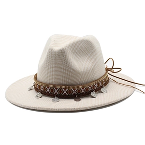 Detail of wool felt fedora featuring woven band with metal coins and leather ties