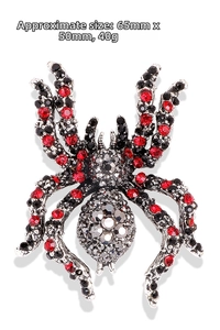 Macro view of crystal spider brooch with red rhinestones and measurements 65x50mm