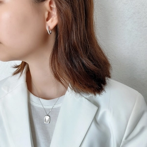 Asian model wearing silver relief pendant necklace and micro-pave studded stud earrings