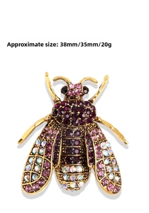 Macro shot of vintage bee brooch with purple crystals and size dimensions 38mm x 35mm