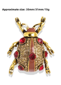 Detail showing beetle insect brooch dimensions 35mm x 31mm with red gems and gold alloy