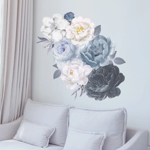 Watercolor blue peony wall decals displayed above a white sofa in a living room