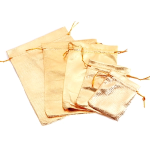 Set of 5 golden drawstring gift bags in various sizes with metallic texture and sheen