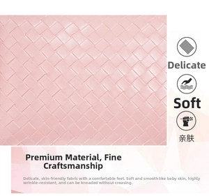 Close-up of pink woven synthetic leather detail featuring classic Intrecciato craft