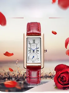 Detail of a square rose gold watch with burgundy leather strap and Roman numerals