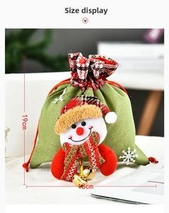 Detailed view of green Christmas drawstring gift bag with a 3D snowman and 19x18cm size