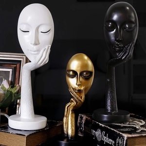Abstract resin face sculptures in white, gold, and black for modern home office decor