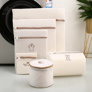 Detailed set of 6 white mesh laundry bags with embroidery icons and brown zippers